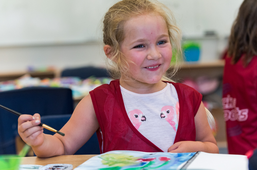 Little girl smiling and doing art activity